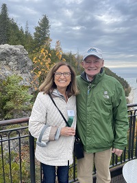 Woman and Man Posing in Front of Mountain